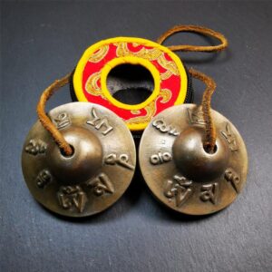 Tingsha hand bells with carved Buddhist mantra “Om Mane Padme Hum"